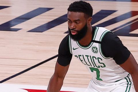 Memphis Grizzlies Kyle Anderson, left, drives the ball against Boston Celtics  Jaylen Brown (7) during the first half of an NBA basketball game Tuesday, Aug. 11, 2020, in Lake Buena Vista, Fla.. AP Photo/Mike Ehrmann, Pool)
