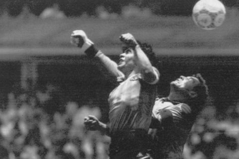 FILE - In this June 22, 1986 file photo  Argentina's Diego Maradona, left, beats England goalkeeper Peter Shilton to a high ball and scores his first of two goals in a World Cup quarterfinal soccer match, in Mexico City. On this day: This was the day of the Hand of God, when Maradona used his left fist to knock a ball past England's Shilton. (AP Photo/El Grafico, Buenos Aires, File)