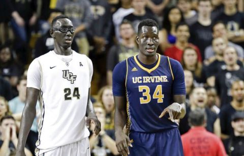 Central Florida center Tacko Fall (24) and UC Irvine center Mamadou Ndiaye (34) play against each other during the second half of an NCAA college basketball game, Wednesday, Nov. 18, 2015, in Orlando, Fla. UC Irvine won 61-60 in overtime. (AP Photo/John Raoux)