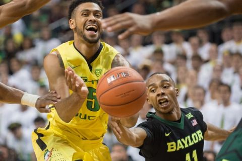 Baylor Bears guard Lester Medford (11) leans in to try and block the pass of Oregon Ducks guard Tyler Dorsey (5). The No. 25 Oregon Ducks take on the No. 20 Baylor Bears at Matthew Knight Arena on Nov. 11, 2015. (Adam Eberhardt/Emerald)