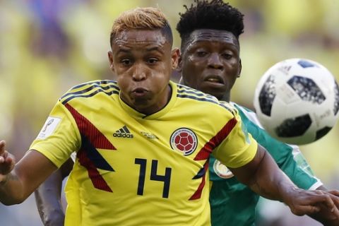 Colombia's Luis Muriel, foreground, and Senegal's Lamine Gassama challenge for the ball during the group H match between Senegal and Colombia, at the 2018 soccer World Cup in the Samara Arena in Samara, Russia, Thursday, June 28, 2018. (AP Photo/Efrem Lukatsky)