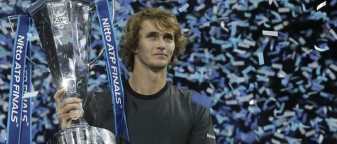 Alexander Zverev of Germany holds the trophy after defeating Novak Djokovic of Serbia in their ATP World Tour Finals singles final tennis match at the O2 Arena in London, Sunday Nov. 18, 2018. (AP Photo/Tim Ireland)