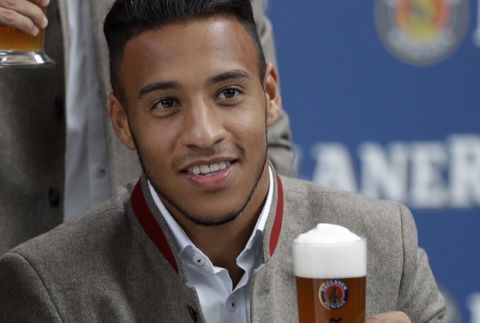 Bayern's Corentin Tolisso poses with beer in traditional Bavarian clothes during a photo shooting of a beer brewing company in Munich, Germany, Wednesday, Sept. 13, 2017. (AP Photo/Matthias Schrader)