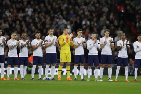 England team applauds before the international friendly soccer match between England and Italy at the Wembley Stadium in London, Tuesday, March 27, 2018. (AP Photo/Kirsty Wigglesworth)