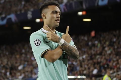 Inter Milan's Lautaro Martinez celebrates after scoring the opening goal of his team during the group F Champions League soccer match between F.C. Barcelona and Inter Milan at the Camp Nou stadium in Barcelona, Spain, Wednesday, Oct. 2, 2019. (AP Photo/Emilio Morenatti)