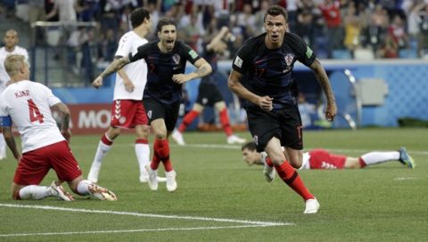 Croatia's Mario Mandzukic, right, celebrates with his teammates after scoring the opening goal of his team during the round of 16 match between Croatia and Denmark at the 2018 soccer World Cup in the Nizhny Novgorod Stadium, in Nizhny Novgorod, Russia, Saturday, July 1, 2018. (AP Photo/Gregorio Borgia)