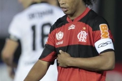 Brazil's Flamengo player Ronaldinho leaves the field after his team lost 3-2 to Paraguay's Olimpia at the end of a Copa Libertadores soccer game in Asuncion, Paraguay, early Thursday March 29, 2012. (AP Photo/Jorge Saenz)