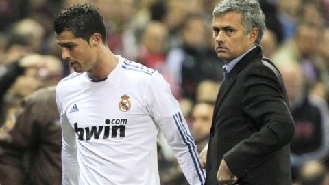 Real Madrid's Cristiano Ronaldo from Portugal, left, celebrates with coach Jose Mourinho form Portugal during a Spanish La Liga soccer match against Atletico Madrid at the Vicente Calderon stadium in Madrid, Saturday, March 19, 2011. (AP Photo/Andres Kudacki)