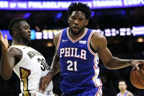 Philadelphia 76ers center Joel Embiid (21) moves around New Orleans Pelicans forward Julius Randle (30) during the second half on an NBA basketball game, Wednesday, Nov. 21, 2018, in Philadelphia. The 76ers won 121-120. (AP Photo/Laurence Kesterson)