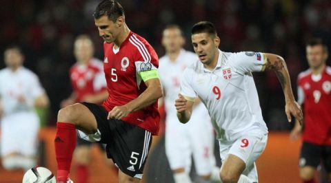 Albania's Lorik Cana (L) vies with Serbia's Aleksandar Mitrovic during the Euro 2016 qualifying football match between Albania and Serbia at the Elbasan Arena in Elbasan on October 8, 2015. AFP PHOTO / GENT SHKULLAKU        (Photo credit should read GENT SHKULLAKU/AFP/Getty Images)