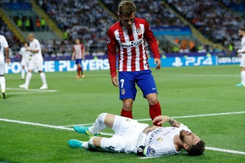 Atletico's Antoine Griezmann checks on Real Madrid's Sergio Ramos after kicking him during the Champions League final soccer match between Real Madrid and Atletico Madrid at the San Siro stadium in Milan, Italy, Saturday, May 28, 2016.  (AP Photo/Manu Fernandez)
