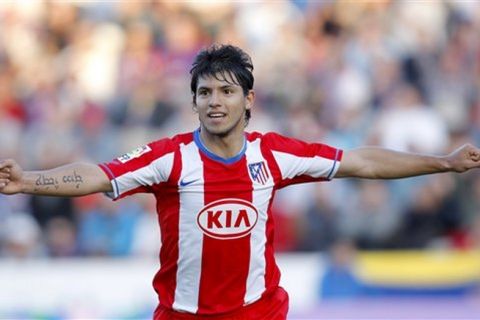 Atletico Madrid player Kun Aguero from Argentina, celebrates after his teammate Diego Forlan scored a goal against Levante during the Spanish League soccer match at the Ciutat de Valencia Stadium in Valencia, Spain, Sunday, Oct. 28, 2007. (AP Photo/Fernando Bustamante)