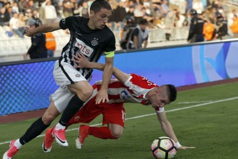 Partizan's Nemanja Vulicevic, left, challenges for a ball with Red Star's Srdjan Plavsic during Serbian National Cup final soccer match between Partizan and Red Star, in Belgrade, Serbia, Saturday, May 27, 2017. (AP Photo/Darko Vojinovic)