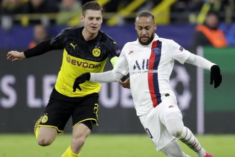 PSG's Neymar, right, duels for the ball with Dortmund's Lukasz Piszczek during the Champions League round of 16 first leg soccer match between Borussia Dortmund and Paris Saint Germain in Dortmund, Germany, Tuesday, Feb. 18, 2020. (AP Photo/Michael Probst)