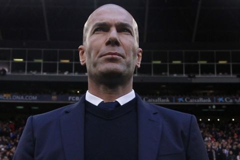 Real Madrid's head coach Zinedine Zidane stands by the bench before the Spanish La Liga soccer match between FC Barcelona and Real Madrid at the Camp Nou in Barcelona, Spain, Saturday, Dec. 3, 2016. (AP Photo/Manu Fernandez)