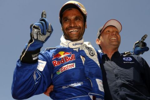 Qatar's driver Nasser Al-Attiyah (L) celebrates with team manager Chris Niessen in Baradero, Buenos Aires Province, on January 15, 2011 after the stage 13 Cordoba - Buenos Aires of the 2011 Dakar Rally. Qatar's Nasser al-Attiyah and German co-driver Timo Gottschalk clinched the Dakar Rally on Saturday, ending two years of heartache on the gruelling event, while defending champion Carlos Sainz was left with the consolation of taking the 13th and final stage.   AFP PHOTO/DANIEL GARCIA (Photo credit should read DANIEL GARCIA/AFP/Getty Images)