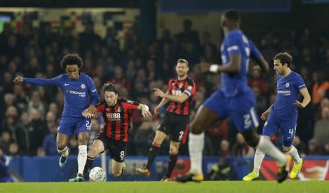 Chelsea's Willian, left, vies for the ball with Bournemouth's Harry Arter during the English League Cup quarterfinal soccer match between Chelsea and Bournemouth at Stamford Bridge stadium in London, Wednesday, Dec. 20, 2017. (AP Photo/Alastair Grant)