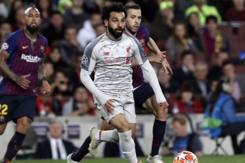 Liverpool's Mohamed Salah runs with the ball during the Champions League semifinal, first leg, soccer match between FC Barcelona and Liverpool at the Camp Nou stadium in Barcelona Spain, Wednesday, May 1, 2019. (AP Photo/Joan Monfort)