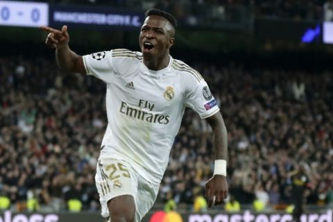 Real Madrid's Vinicius Junior celebrates after Real Madrid's Isco scores his side's opening goal during the Champions League, round of 16, first leg soccer match between Real Madrid and Manchester City at the Santiago Bernabeu stadium in Madrid, Spain, Wednesday, Feb. 26, 2020. (AP Photo/Manu Fernandez)