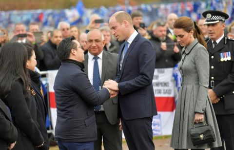 Leicester City Vice chairman Aiyawatt Srivaddhanaprabha, the son of deceased owner Vichai Srivaddhanaprabha, left, shakes hands and talks with Britain's Prince William and Kate, Duchess The Duke of Cambridge, as they view tributes to those who were killed in an helicopter crash at Leicester City Football Club's King Power Stadium in Leicester, England, Wednesday, Nov. 28, 2018. Vichai Srivaddhanaprabha, the Thai billionaire owner of Premier League team Leicester City was among five people who died after his helicopter crashed and burst into flames shortly after taking off from the soccer field on Saturday Oct. 27, 2018. (AP Photo/Arthur Edwards)