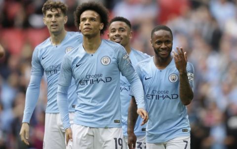 Manchester City's Raheem Sterling, right, celebrates after scoring his side's sixth goal during the English FA Cup Final soccer match between Manchester City and Watford at Wembley stadium in London, Saturday, May 18, 2019. (AP Photo/Tim Ireland)