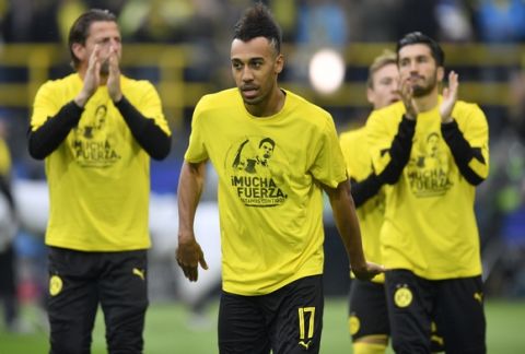 Dortmund's Pierre-Emerick Aubameyang wears a t-shirt 'A lot of strength - we are with you" for his teammate Marc Bartra who was injured after an explosion the day before prior to the Champions League quarterfinal irst leg soccer match between Borussia Dortmund and AS Monaco in Dortmund, Germany, Wednesday, April 12, 2017. (AP Photo/Martin Meissner)