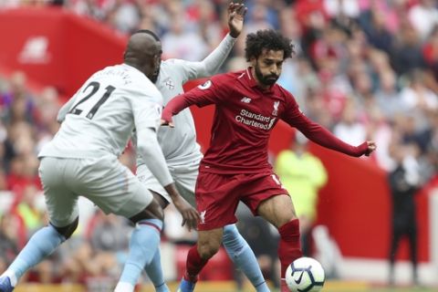 Liverpool's Mohamed Salah , right, in action during the Premier League match at Anfield, Liverpool, England. Sunday Aug.12, 2018. (David Davies/PA via AP)