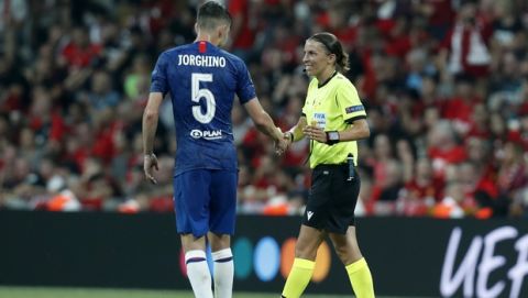 Chelsea's Jorginho, left, shakes hand with referee Stephanie Frappart of France during the UEFA Super Cup soccer match between Liverpool and Chelsea, in Besiktas Park, in Istanbul, Wednesday, Aug. 14, 2019.(AP Photo/Lefteris Pitarakis)