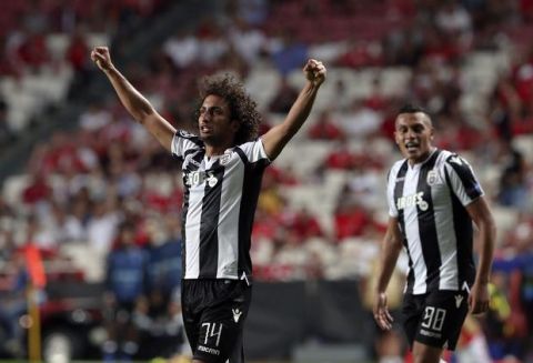 PAOK's Amr Warda, left, celebrates scoring his side's first goal during the Champions League playoffs, first leg, soccer match between Benfica and PAOK at the Luz stadium in Lisbon, Tuesday, Aug. 21, 2018. (AP Photo/Armando Franca)