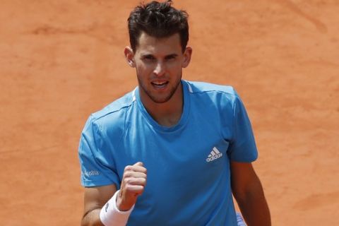 Austria's Dominic Thiem clenches his fist after scoring a point against Serbia's Novak Djokovic during the men's semifinal match of the French Open tennis tournament at the Roland Garros stadium in Paris, Saturday, June 8, 2019. (AP Photo/Christophe Ena)