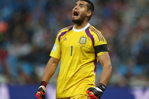 SAO PAULO, BRAZIL - JULY 09:  Sergio Romero of Argentina reacts after saving the penalty kick of Wesley Sneijder of the Netherlands (not pictured) in a shootout during the 2014 FIFA World Cup Brazil Semi Final match between the Netherlands and Argentina at Arena de Sao Paulo on July 9, 2014 in Sao Paulo, Brazil.  (Photo by Ronald Martinez/Getty Images)