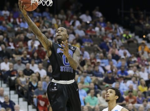 Georgia State guard Kevin Ware, left, makes a shot in front of Xavier 's Dee Davis (11) during the first half of an NCAA tournament third round college basketball game, Saturday, March 21, 2015, in Jacksonville, Fla. (AP Photo/Chris O'Meara)