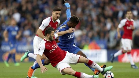 Leicester City's Kelechi Iheanacho, right, and Arsenal's Sead Kolasinac battle for the ball during the English Premier League soccer match at the King Power Stadium, Leicester, England, Wednesday May 9, 2018. (David Davies/PA via AP)