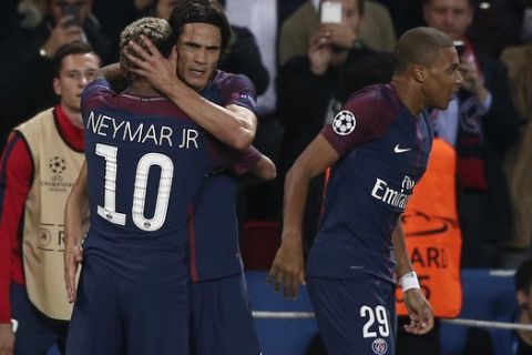 PSG's Neymar (10) is congratulated by teammate Edinson Cavani, background, besides PSG's Kylian Mbappe after scoring his side's third goal during the Champions League Group B soccer match between Paris Saint-Germain and Bayern Munich in Paris, France, Wednesday, Sept. 27, 2017. (AP Photo/Thibault Camus)