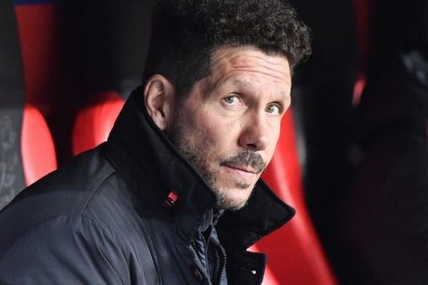 Atletico's head coach Diego Simeone waits for the beginning of the Champions League round of 16 first leg soccer match between Bayer Leverkusen and Atletico Madrid in Leverkusen, Germany, Tuesday, Feb. 21, 2017. (AP Photo/Martin Meissner)
