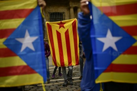 Pro independence supporters hold up ''esteleda'' or Catalan pro independence flags, in support of the Catalonia's secession referendum, in Pamplona, northern Spain, Sunday, Oct. 1, 2017. Catalan pro-referendum supporters vowed Saturday to ignore a police ultimatum to leave the schools they are occupying for use in a referendum vote on seeking independence from Spain. (AP Photo/Alvaro Barrientos)