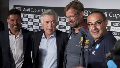 From left: Athletico Madrid coach  Diego Simeone , Bayern Munich coach Carlo Ancelotti,  FC Liverpool coach Juergen Klopp and  Maurizio Sarri coach of SSC Napoli attend a news conference in Munich Germany, Monday, July 31, 2017. The teams will meet in the preseason Audi Cup on Tuesday and Wednesday this week. (Sven Hoppe/dpa via AP)
