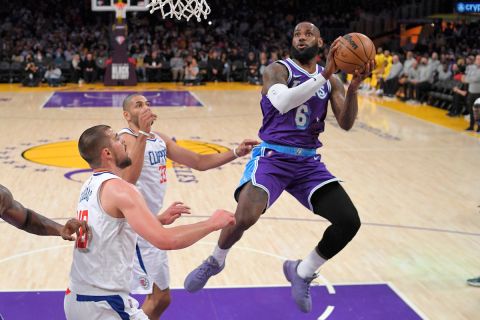 Los Angeles Lakers forward LeBron James, right, shoots as Los Angeles Clippers center Ivica Zubac, left, and forward Nicolas Batum defend during the first half of an NBA basketball game Friday, Feb. 25, 2022, in Los Angeles. (AP Photo/Mark J. Terrill)