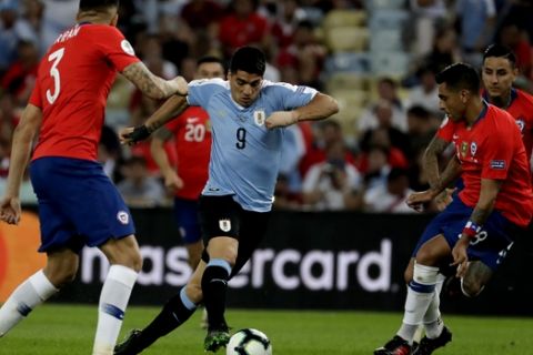 Uruguay's Luis Suarez, center, is challenged by Chile's Guillermo Maripan, left, and Gonzalo Jara during a Copa America Group C soccer match at the Maracana stadium in Rio de Janeiro, Brazil, Monday, June 24, 2019. (AP Photo/Leo Correa)