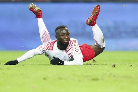 In this Jan. 13, 2018 photo, Leipzig's Naby Deco Keita is  on the ground during the German Bundesliga soccer match between RB Leipzig and FC Schalke 04 at the Red Bull Arena in Leipzig, Germany. Leipzig ruled out a winter transfer for Naby Keita on Sunday, Jan 14, 2018, saying the Guinea midfielder will stay with the side to the end of the season. The Bundesliga side said in a tweet that Keita will stay a Leipzig player until June 30 and "we wish to put the speculation about a January move to (Liverpool) to bed". ( Jan Woitas/dpa via AP)