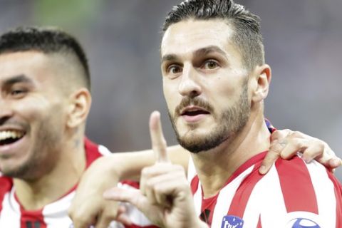 Atletico Madrid's Koke celebrates his side opening goal with Atletico Madrid's Angel Correa during the Spanish Super Cup semifinal soccer match between Barcelona and Atletico Madrid at King Abdullah stadium in Jiddah, Saudi Arabia, Thursday, Jan. 9, 2020. (AP Photo/Hassan Ammar)