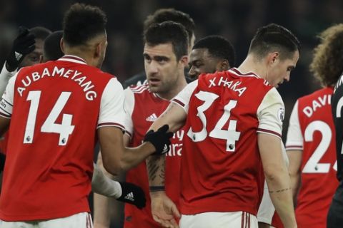 Arsenal's Sokratis Papastathopoulos, center, celebrates with teammates after scoring their side's second goal during the English Premier League soccer match between Arsenal and Manchester United at the Emirates Stadium in London, Wednesday, Jan. 1, 2020. (AP Photo/Matt Dunham)