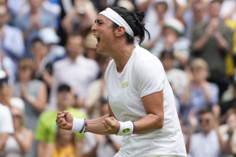 Tunisia's Ons Jabeur celebrates after beating Kazakhstan's Elena Rybakina to win their women's singles match on day ten of the Wimbledon tennis championships in London, Wednesday, July 12, 2023. (AP Photo/Kirsty Wigglesworth)