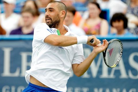 WASHINGTON, DC - AUGUST 05:  Marcos Baghdatis of Cyprus returns a shot to Donald Young during the quarterfinals of the Legg Mason Tennis Classic presented by Geico at the William H.G. FitzGerald Tennis Center on August 5, 2011 in Washington, DC.  (Photo by Matthew Stockman/Getty Images)
