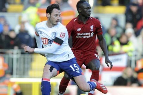 Bournemouth's Adam Smith, left, vie for the ball with Liverpool's Sadio Mane during the English Premier League soccer match between Liverpool and AFC Bournemouth at Anfield stadium in Liverpool, England, Saturday, Feb. 9, 2019. (AP Photo/Rui Vieira)