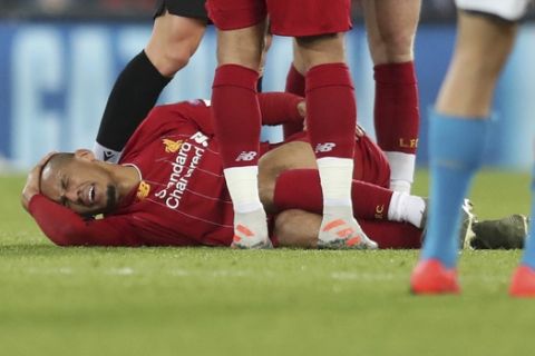 Liverpool's Fabinho lies injured before leaving the game during the Champions League Group E soccer match between Liverpool and Napoli at Anfield stadium in Liverpool, England, Wednesday, Nov. 27, 2019. (AP Photo/Jon Super)