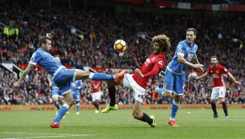 AFC Bournemouth's Steve Cook, left, and Manchester United's Marouane Fellaini battle for the ball during their English Premier League soccer match at Old Trafford, Manchester, England, Saturday, March 4, 2017. (Martin Rickett/PA via AP)