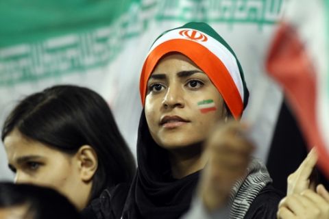 Iranian young woman fans watch their team winning during their 2014 World Cup Asian zone qualifying football match between Qatar and Iran at the Al-Sadd stadium in Doha on, Tuesday,June, 4, 2013. (AP Photo/Osama Faisal)