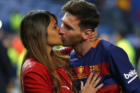 FILE - In this Sunday, May 22, 2016 file photo, Barcelona's Lionel Messi kisses his wife Antonella Roccuzzo as they celebrate after winning the final of the Copa del Rey soccer match between FC Barcelona and Sevilla FC at the Vicente Calderon stadium in Madrid. Cristiano Ronaldo and Lionel Messi put up impressive numbers, in life and on the field, going into a fourth World Cup for each. So much has happened for football's standout stars since the 2014 tournament left both still lacking the game's most coveted prize. (AP Photo/Francisco Seco, File)