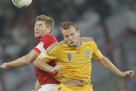 England's Steven Gerrard, left, vies for the ball with Ukraine's Oleh Gusev during the World Cup group H qualifier soccer match between England  and Ukraine at the Olympiyskiy national stadium in Kiev, Ukraine, Tuesday, Sept. 10, 2013.(AP Photo/Efrem Lukatsky)